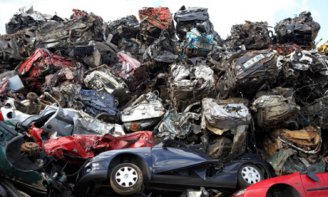 Piles of crushed cars at a metal recycling site in Belfast, Northern Ireland. Photograph: Alamy